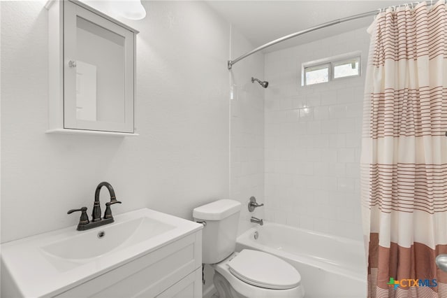 bathroom featuring vanity, shower / tub combo, and toilet