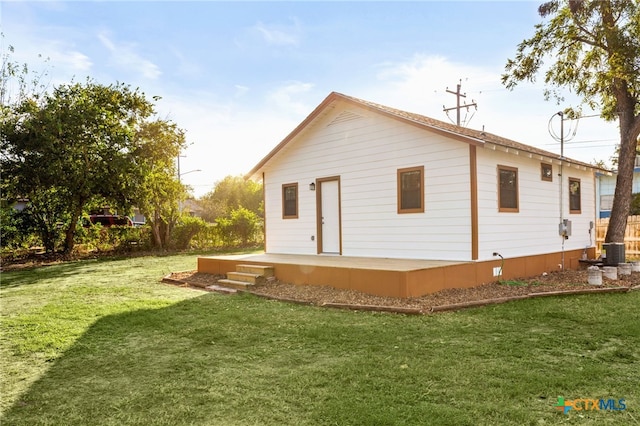 rear view of house with a lawn