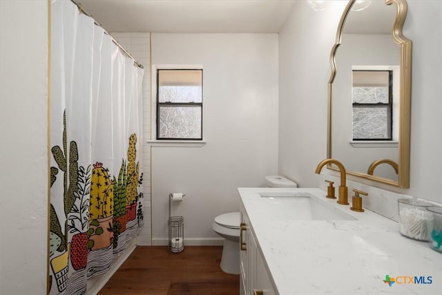 bathroom featuring vanity, hardwood / wood-style flooring, curtained shower, and toilet