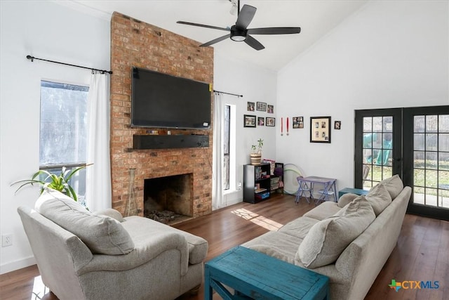 living room with french doors, ceiling fan, a fireplace, and dark hardwood / wood-style flooring