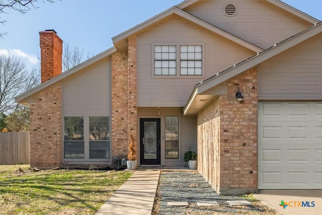 view of front of home with a garage and a front yard