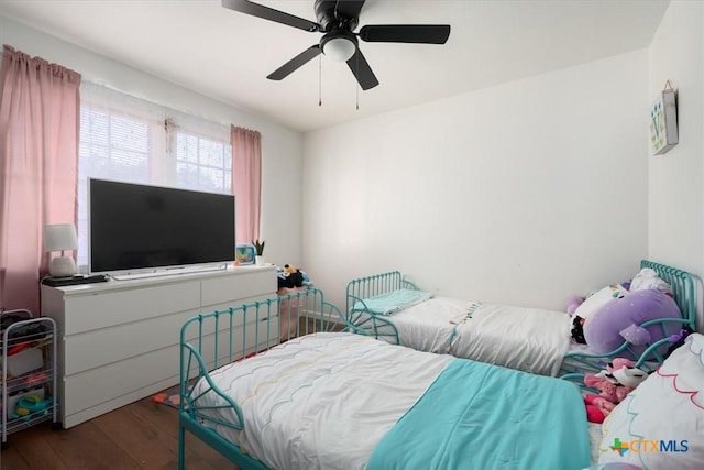 bedroom with dark hardwood / wood-style floors and ceiling fan