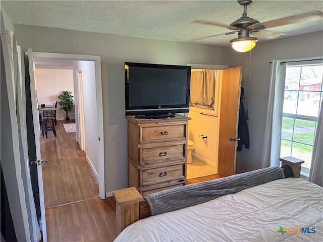 4912 Evergreen Ln, Victoria, TX 77904 - bedroom featuring wood finished floors, a textured ceiling, and ensuite bathroom