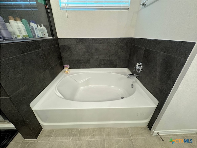 bathroom featuring tile walls, a bathtub, and tile patterned floors