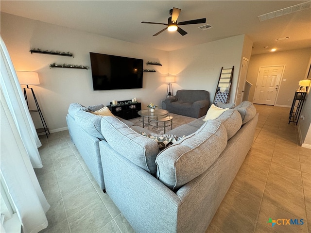 living room with ceiling fan and tile patterned floors