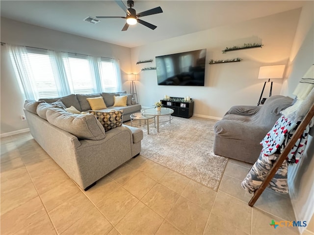 living room with ceiling fan and light tile patterned flooring