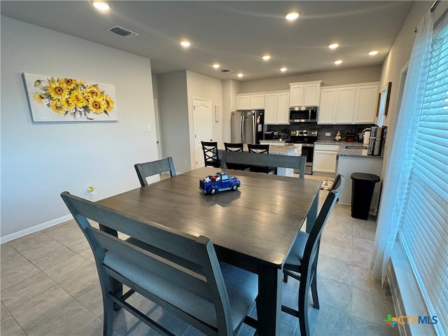 dining room featuring light tile patterned flooring and sink