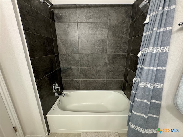 bathroom with shower / bathtub combination with curtain