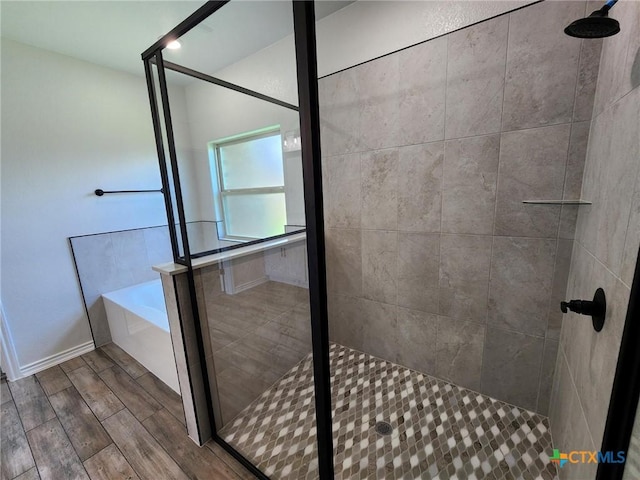 719 Eagle Claw Dr, Salado, TX 76571 - bathroom with a stall shower, a garden tub, and wood finished floors