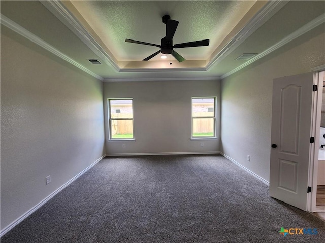 719 Eagle Claw Dr, Salado, TX 76571 - spare room with a tray ceiling, healthy amount of natural light, dark carpet, a ceiling fan, and a textured ceiling