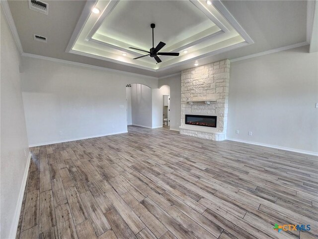 719 Eagle Claw Dr, Salado, TX 76571 - unfurnished living room with a raised ceiling, a ceiling fan, wood finished floors, and crown molding