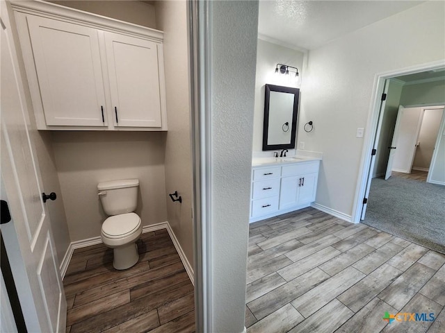 719 Eagle Claw Dr, Salado, TX 76571 - bathroom with wood finished floors, vanity, toilet, and baseboards