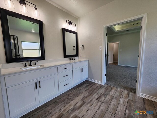 719 Eagle Claw Dr, Salado, TX 76571 - full bath with wood finished floors, double vanity, and baseboards