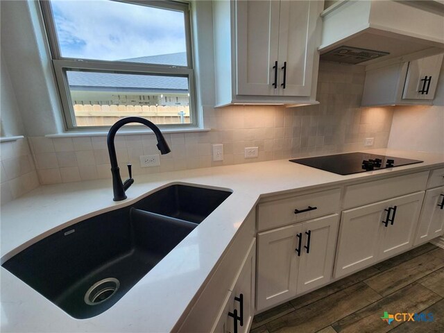 719 Eagle Claw Dr, Salado, TX 76571 - kitchen with a sink, black electric cooktop, dark wood-style flooring, and tasteful backsplash