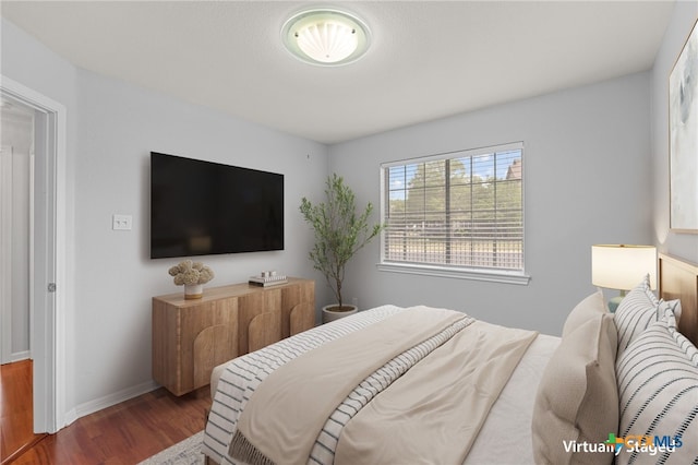 30388 Ledgemont Ln Drive, Georgetown, TX 78628 - bedroom with wood finished floors and baseboards