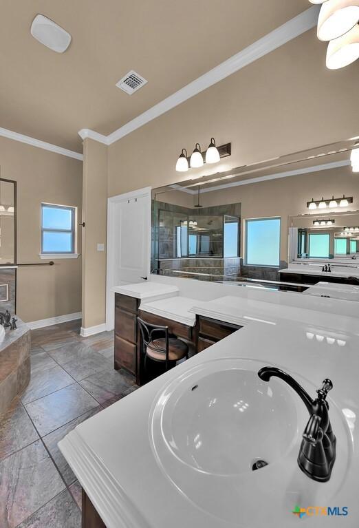 full bathroom with a bath, visible vents, a shower with shower door, ornamental molding, and vanity