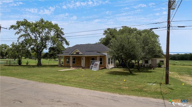 210 Julia St, Yoakum, TX 77995 - view of front of property featuring a porch and a front yard