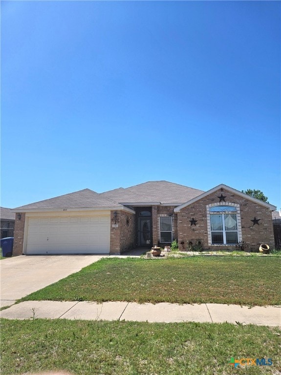 2415 Merle Dr, Copperas Cove, TX 76522 - view of front facade featuring brick siding, concrete driveway, an attached garage, and a front yard