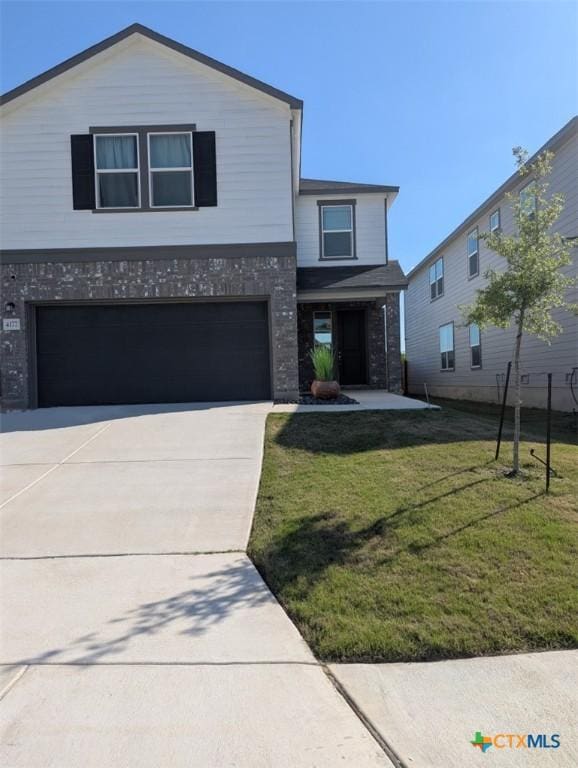 4177 Harper Lee Ln, New Braunfels, TX 78130 - view of front of home featuring brick siding, an attached garage, a front lawn, and concrete driveway