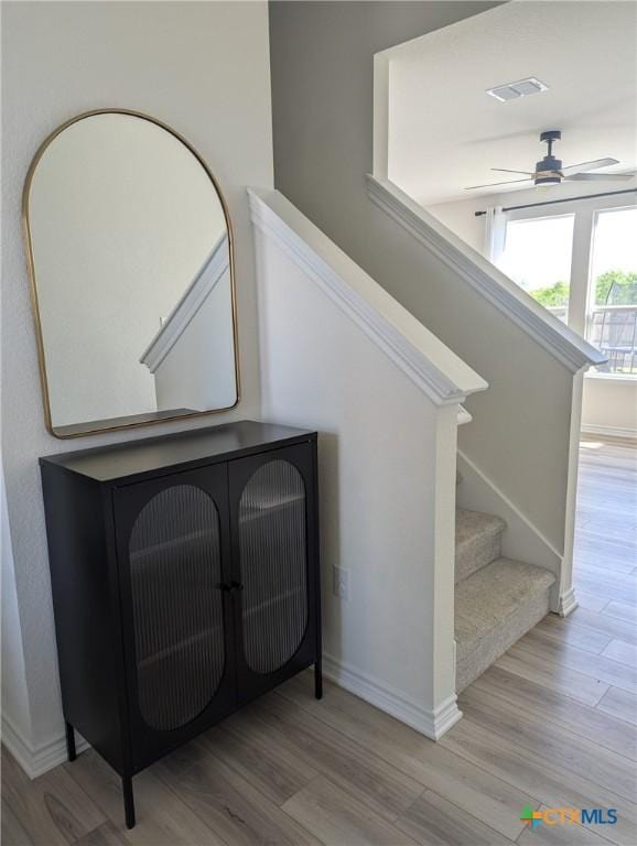 4177 Harper Lee Ln, New Braunfels, TX 78130 - staircase with wood finished floors, a ceiling fan, and baseboards