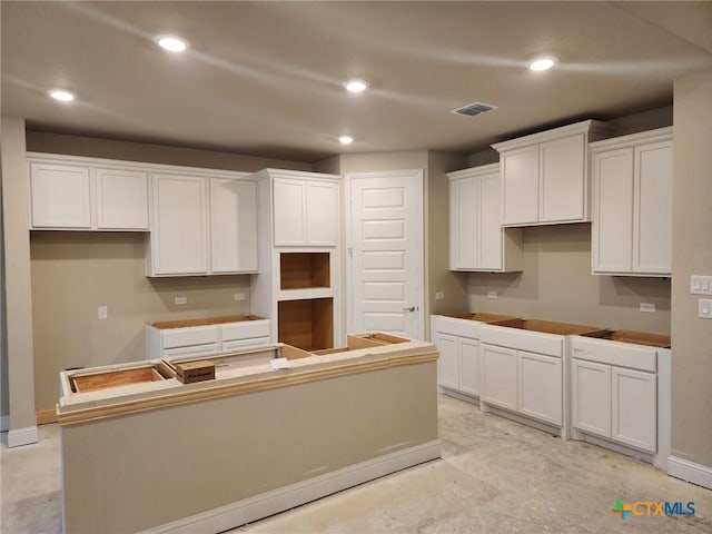 kitchen with a center island and white cabinetry