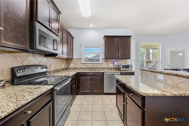 5920 Stonehaven Dr, Temple, TX 76502 - kitchen featuring appliances with stainless steel finishes, a sink, backsplash, dark brown cabinetry, and light tile patterned floors
