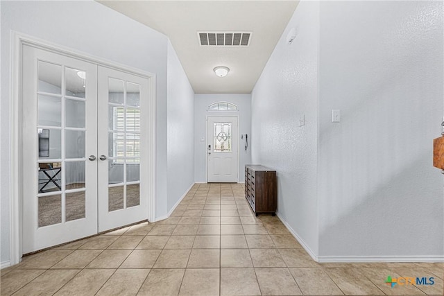 5920 Stonehaven Dr, Temple, TX 76502 - entryway with french doors, baseboards, and light tile patterned flooring