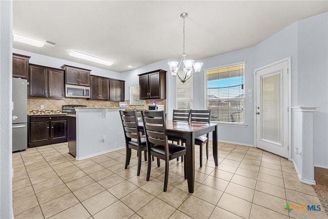 5920 Stonehaven Dr, Temple, TX 76502 - dining area with a chandelier and light tile patterned flooring