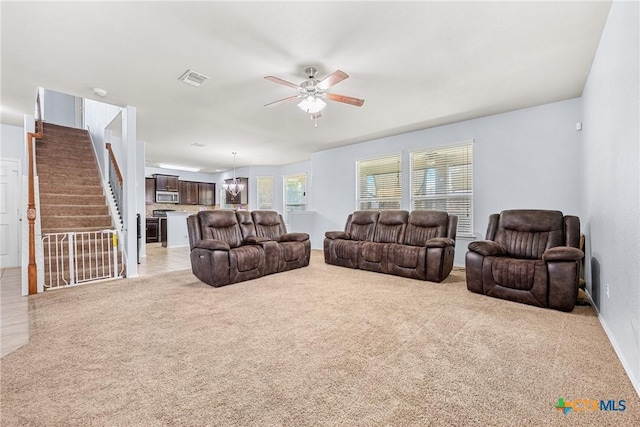 5920 Stonehaven Dr, Temple, TX 76502 - living area with ceiling fan, light carpet, stairs, and baseboards