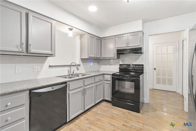 kitchen with gray cabinets, sink, light hardwood / wood-style flooring, and black appliances