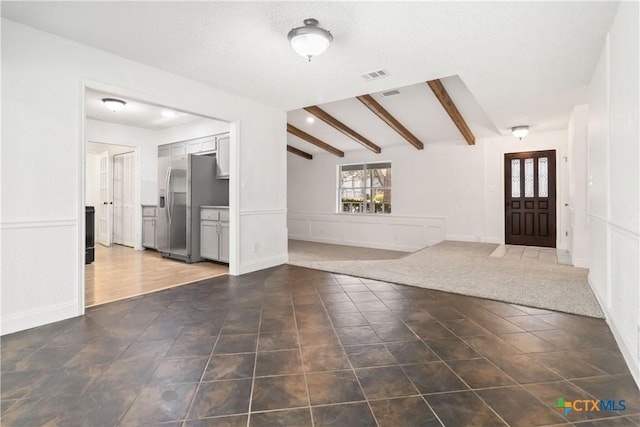 tiled entrance foyer featuring vaulted ceiling with beams