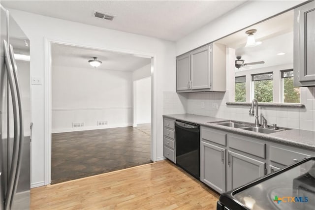 kitchen featuring gray cabinetry, sink, stainless steel fridge, and dishwasher