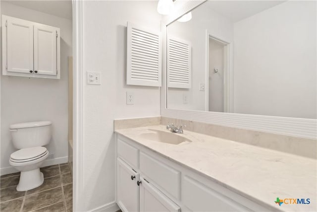 bathroom with vanity, tile patterned floors, and toilet