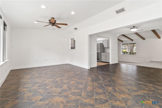 unfurnished living room with beamed ceiling and ceiling fan