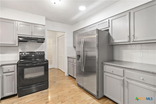 kitchen featuring black / electric stove, stainless steel fridge with ice dispenser, and gray cabinetry