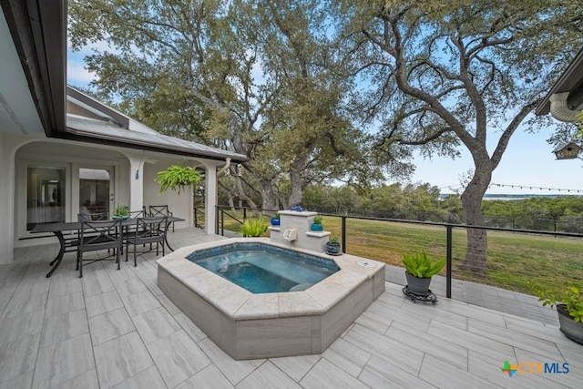 view of swimming pool with an in ground hot tub, a lawn, and a patio area