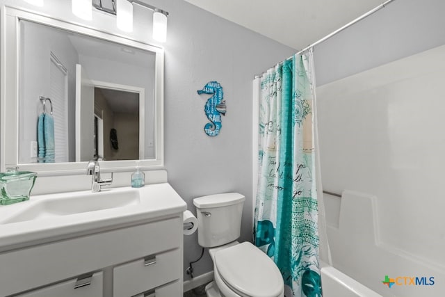 full bathroom featuring toilet, vanity, and shower / bathtub combination with curtain