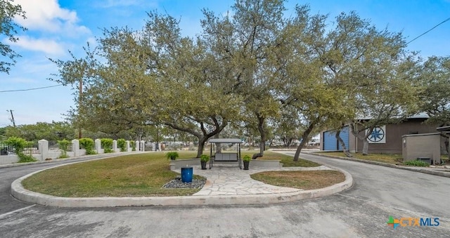 view of property's community with a lawn