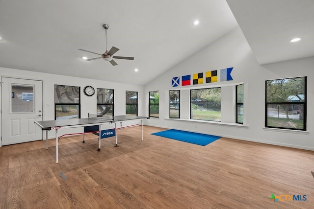 playroom with light wood-type flooring, ceiling fan, and high vaulted ceiling