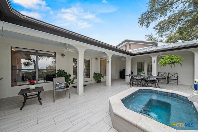 view of swimming pool featuring a patio area, a ceiling fan, and outdoor dining space