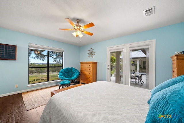 bedroom featuring access to exterior, ceiling fan, and wood-type flooring