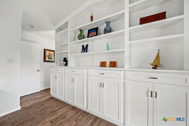 interior details featuring hardwood / wood-style floors and built in shelves