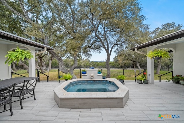 view of pool featuring an in ground hot tub and a patio