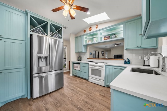 kitchen featuring open shelves, backsplash, a sink, white appliances, and ceiling fan