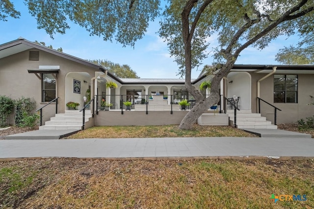 exterior space with covered porch and stucco siding