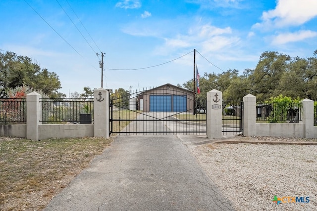 view of gate with a garage