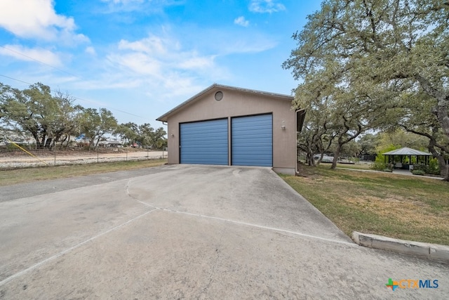 garage featuring a lawn