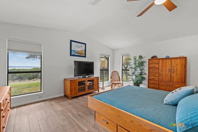 bedroom with multiple windows, light hardwood / wood-style flooring, ceiling fan, and vaulted ceiling