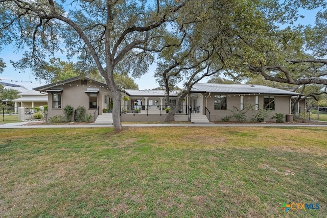 ranch-style home featuring stucco siding, a front lawn, and central air condition unit