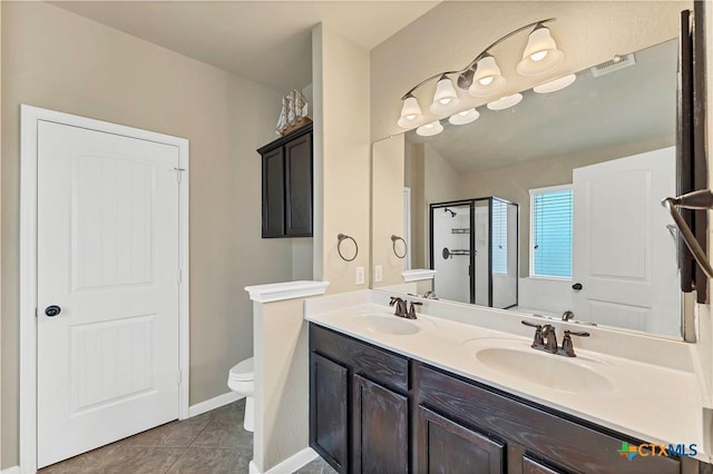 full bathroom featuring a sink, toilet, a stall shower, and tile patterned flooring